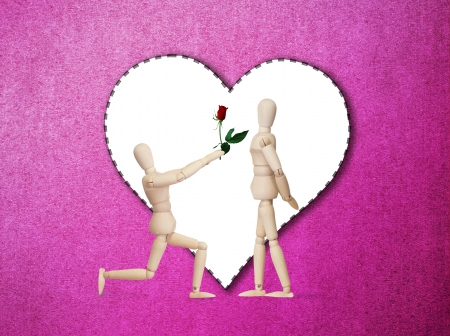 Wooden model handing over love gift to friend on Valentine dayの写真素材
