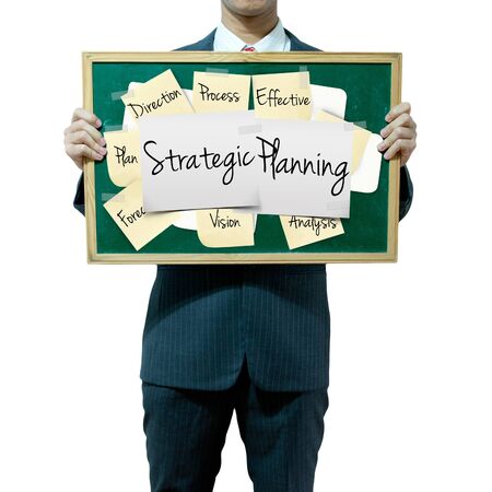 Business man holding board on the background, Strategic Planning conceptの写真素材