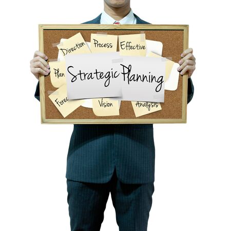 Business man holding board on the background, Strategic Planning conceptの写真素材