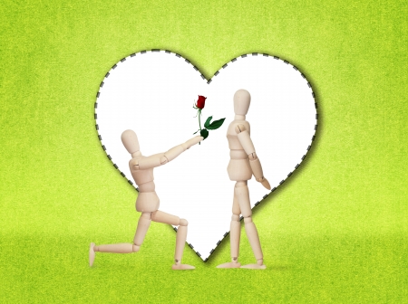 Wooden model handing over love gift to friend on Valentine dayの写真素材