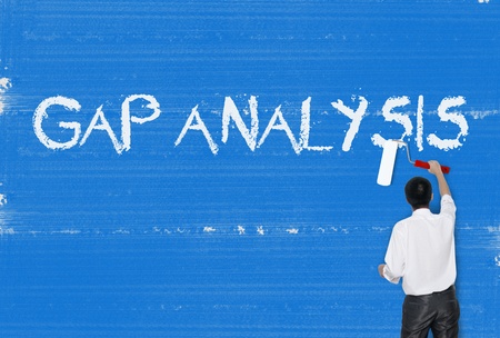 Man painting word on cement texture wall background, Gap analysisの写真素材