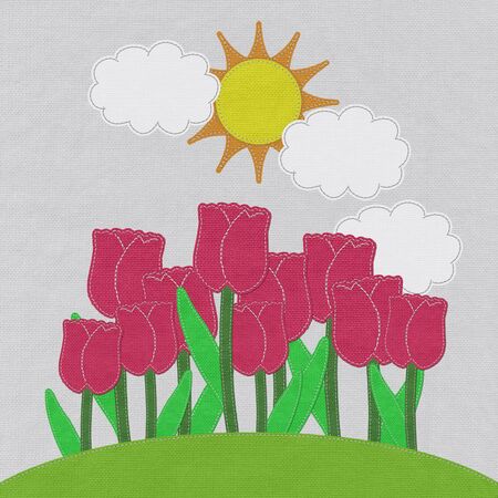 Tulip on green grass field with stitch style fabric backgroundの写真素材