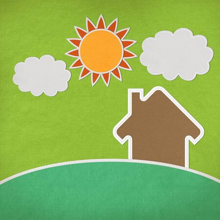 Landscape of green grass and home with stitch style on fabrix backgroundの写真素材