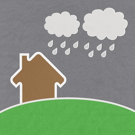 Landscape of green grass and home with stitch style on fabrix backgroundの写真素材