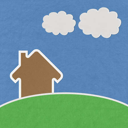 Landscape of green grass and home with stitch style on fabrix backgroundの写真素材