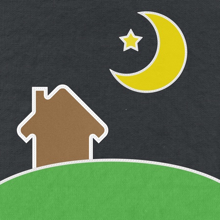 Landscape of green grass and home with stitch style on fabrix backgroundの写真素材
