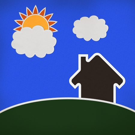 Landscape of green grass and home with stitch style on fabrix backgroundの写真素材