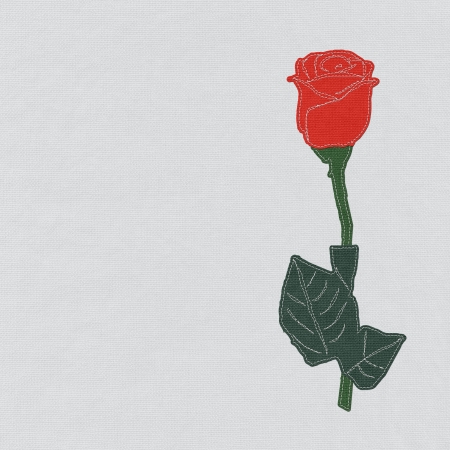 Red rose with stitch style on fabric backgroundの写真素材