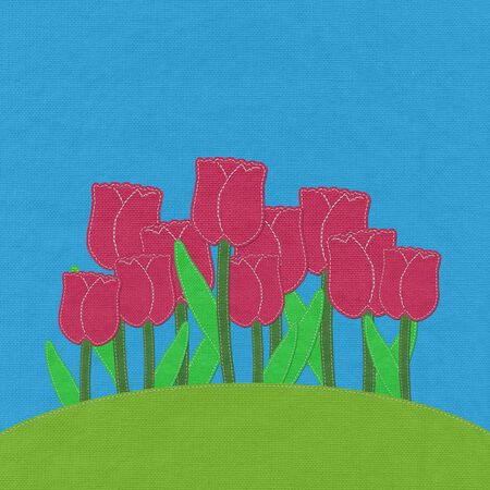 Tulip on green grass field with stitch style fabric backgroundの写真素材
