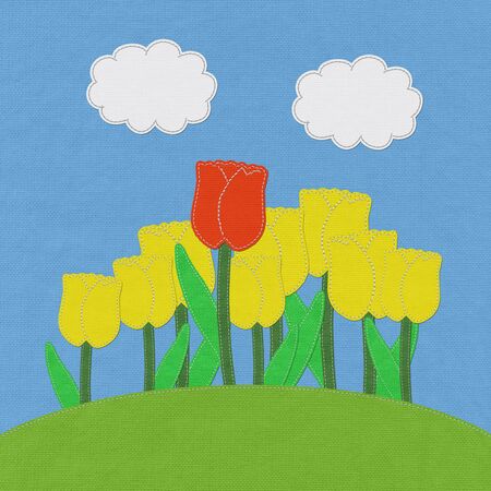 Tulip on green grass field with stitch style fabric backgroundの写真素材