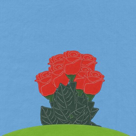 Red rose on green grass field with stitch style fabric backgroundの写真素材