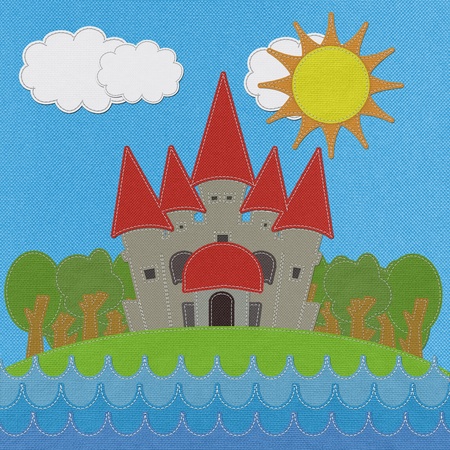 Fairy-tale castle on a green field with stitch style on fabric backgroundの写真素材