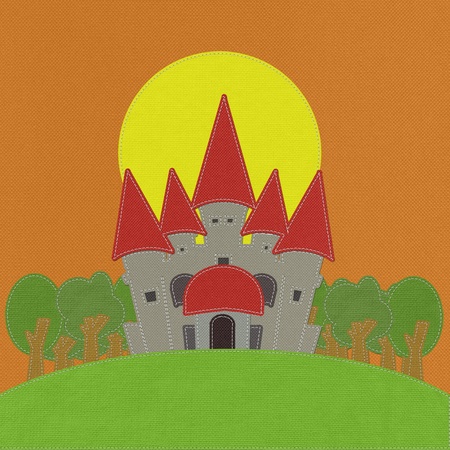 Fairy-tale castle on a green field with stitch style on fabric backgroundの写真素材
