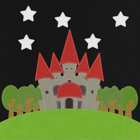 Fairy-tale castle on a green field with stitch style on fabric backgroundの写真素材
