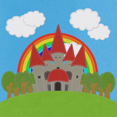 Fairy-tale castle on a green field with stitch style on fabric backgroundの写真素材
