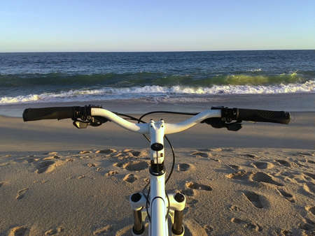 Bike on the sand beach sunsetの写真素材