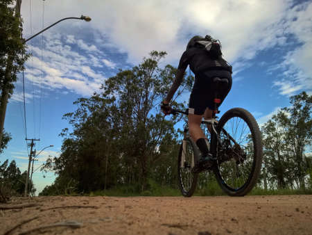 Cyclist riding on the rural roadの写真素材