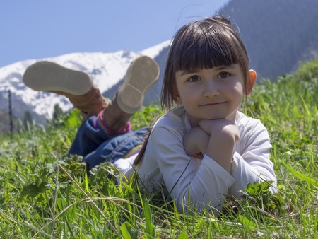 Girl dreams in meadow mountain backgroundの写真素材