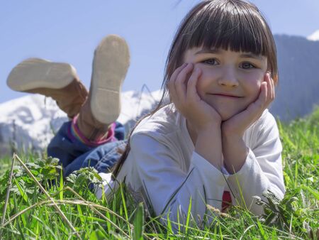 Girl dreams in meadow mountain backgroundの写真素材