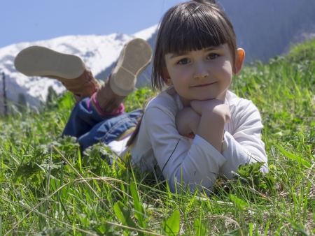 Girl dreams in meadow mountain backgroundの写真素材