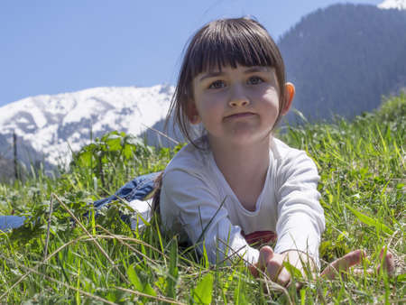 Girl dreams in meadow mountain backgroundの写真素材