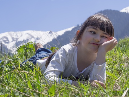 Girl dreams in meadow mountain backgroundの写真素材