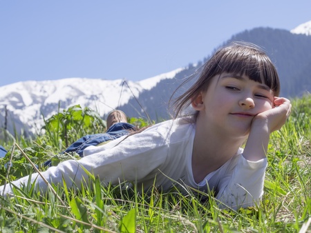 Girl dreams in meadow mountain backgroundの写真素材