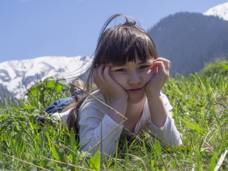 Girl dreams in meadow mountain backgroundの写真素材