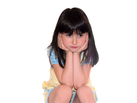 Nice pretty sad girl sitting isolated on white