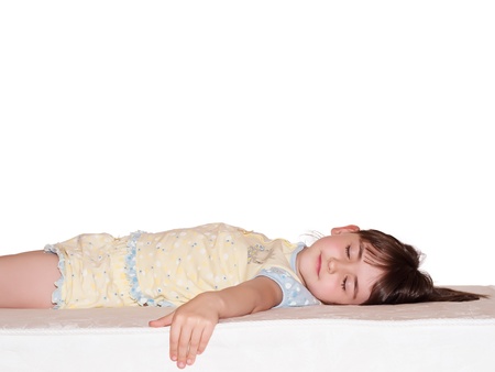 Caucasian girl sleep on the big white mattressの写真素材
