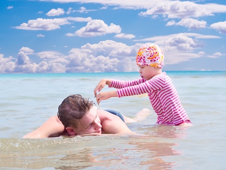 Happy fatherhood in the beachの写真素材