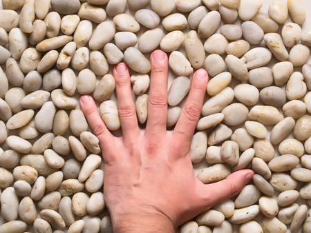 Spa stones and hand の写真素材