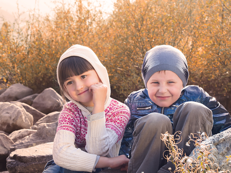 Autumn portrait of boy and girlの写真素材