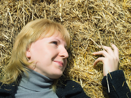 Girl in nature hay backgroundの写真素材
