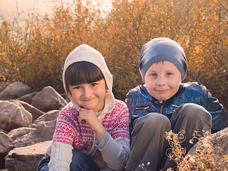 Autumn portrait of boy and girlの写真素材