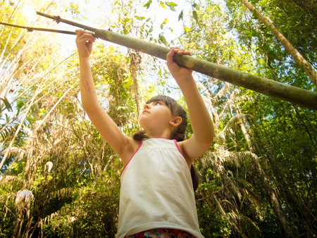 Caucasian child girl walking at the wild jungeの写真素材
