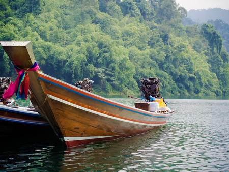 Longtail boats at the pier in Thai, Cheow Lan Lake, Khao Sok Nationalの写真素材