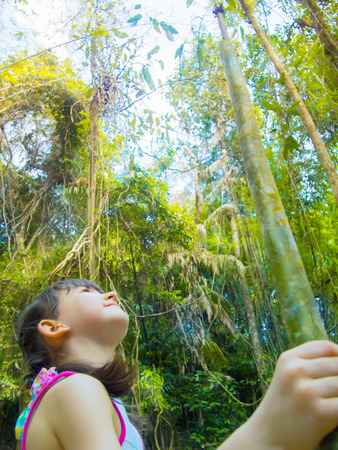 Caucasian child girl walking at the wild jungeの写真素材