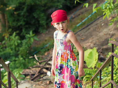 Portrait of little caucasian emotional girl in a bandanaの写真素材