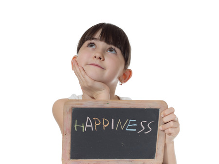Young caucasian girl holding chalkboard signed happiness isolated on whiteの写真素材