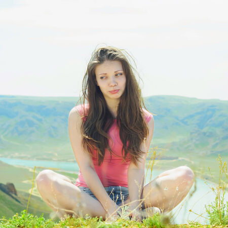 Portrait of young caucasian beautiful sport  women in summer nature on the background of river in blue pantsの写真素材