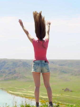 Portrait of young caucasian beautiful sport  women in summer nature on the background of river in blue pantsの写真素材