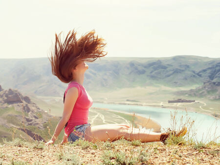 Portrait of young caucasian beautiful sport  women in summer nature on the background of river in blue pantsの写真素材