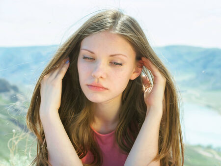 Portrait of young caucasian beautiful sport women lying on travel mat  in summer nature on the background of riverの写真素材