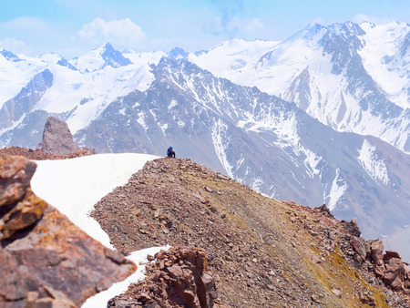 Climber hiking sportsman rest on the rock of the background of mountain peak