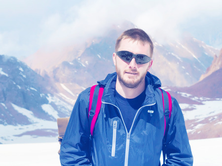 Young caucasian climber sportsman hiking to the mountain peakの写真素材