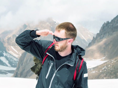 Young caucasian climber sportsman hiking to the mountain peakの写真素材