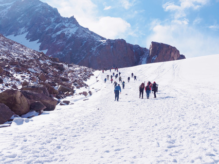Group of climbers sportsmen hiking to the mountain peakの写真素材