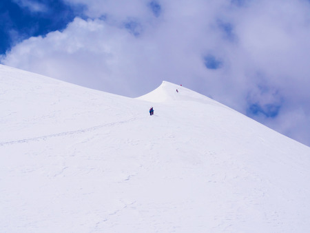 Group of climbers sportsmen hiking to the mountain peakの写真素材