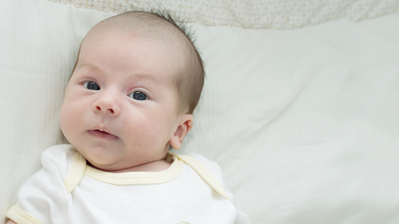 Portrait of face funny caucasian newborn toddler baby boyの写真素材